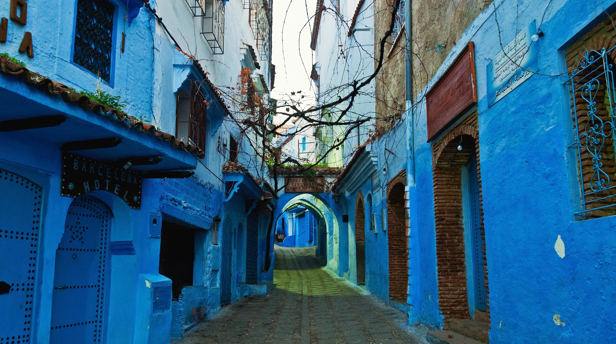 A blue-painted lane with an archway in the Chefchaouen medina, Morocco