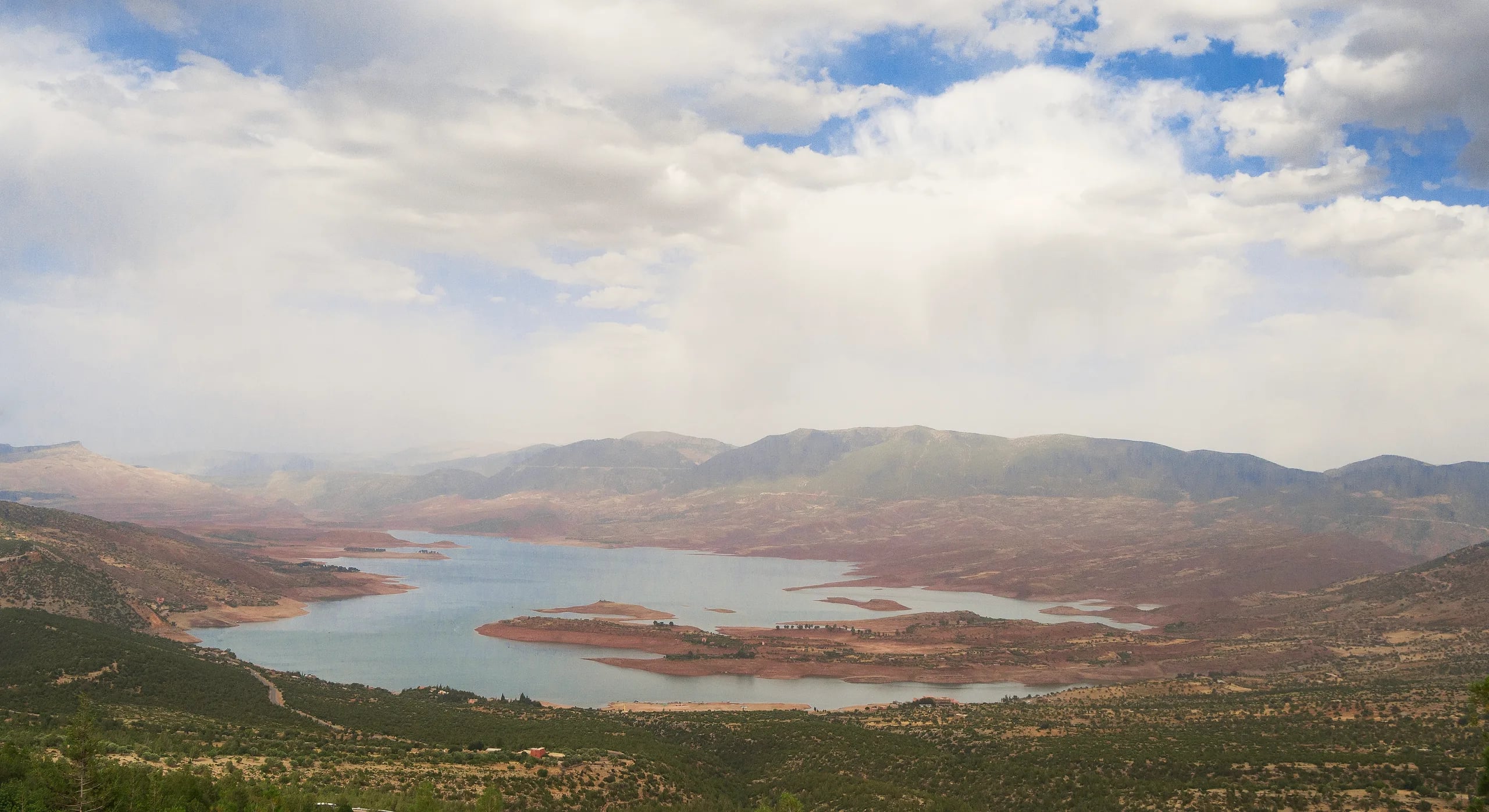 Bin El Ouidane reservoir from the hills above, its arms of water between red shores