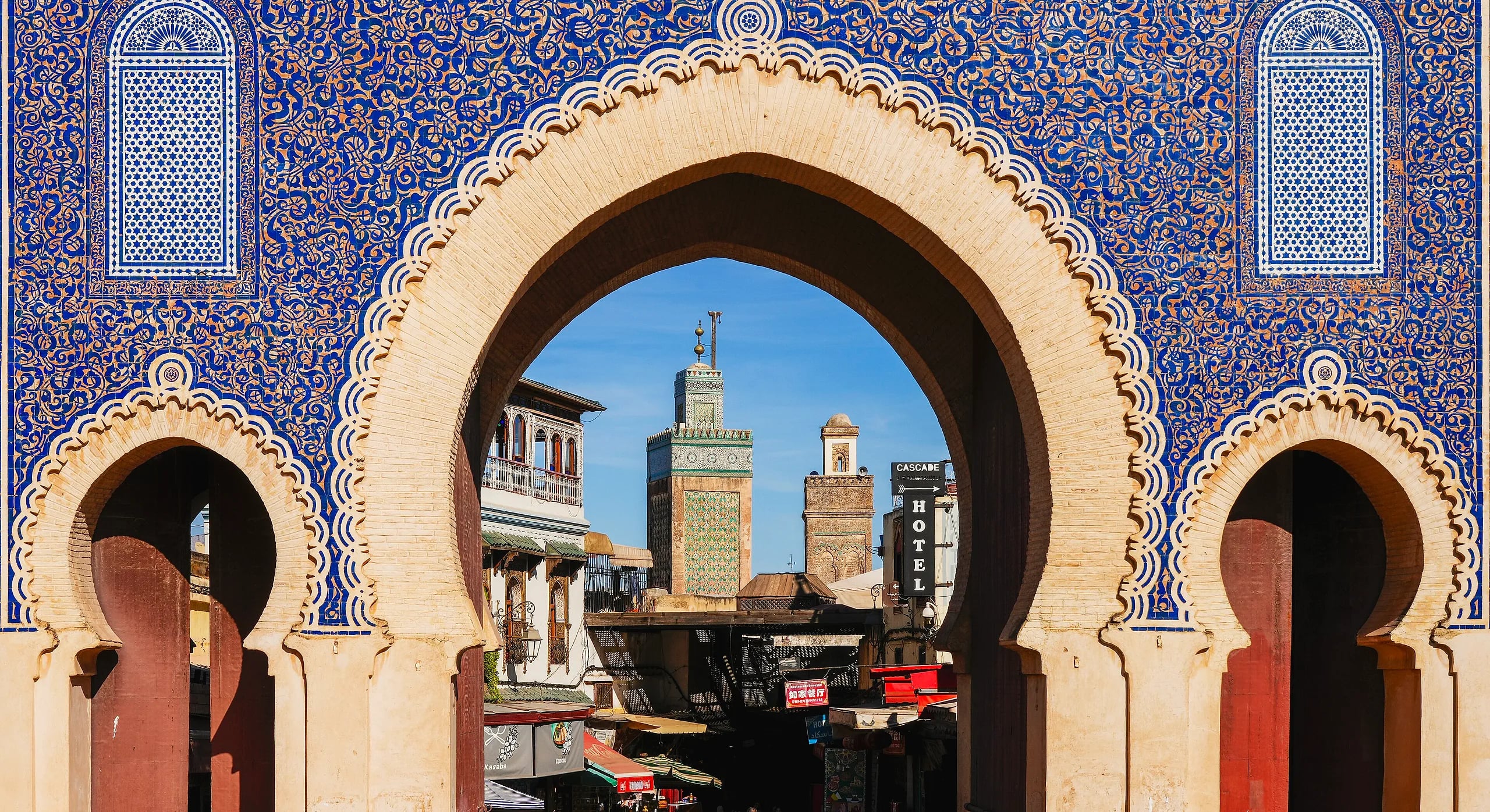 Bab Bou Jeloud, the blue-tiled gate into the Fes medina, with minarets framed in its arch