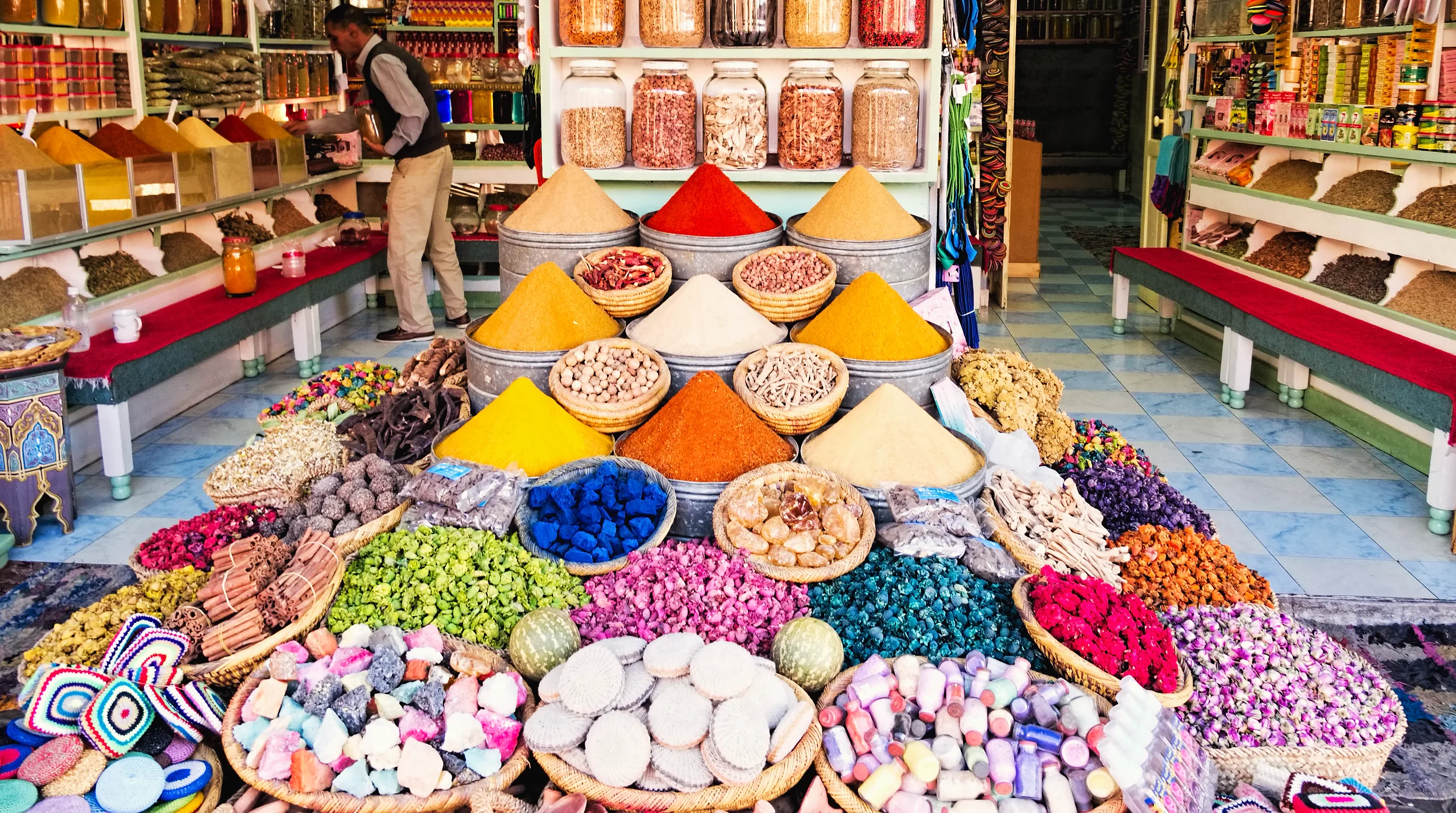 Cones of spices and baskets of dried flowers at a spice shop in the souks