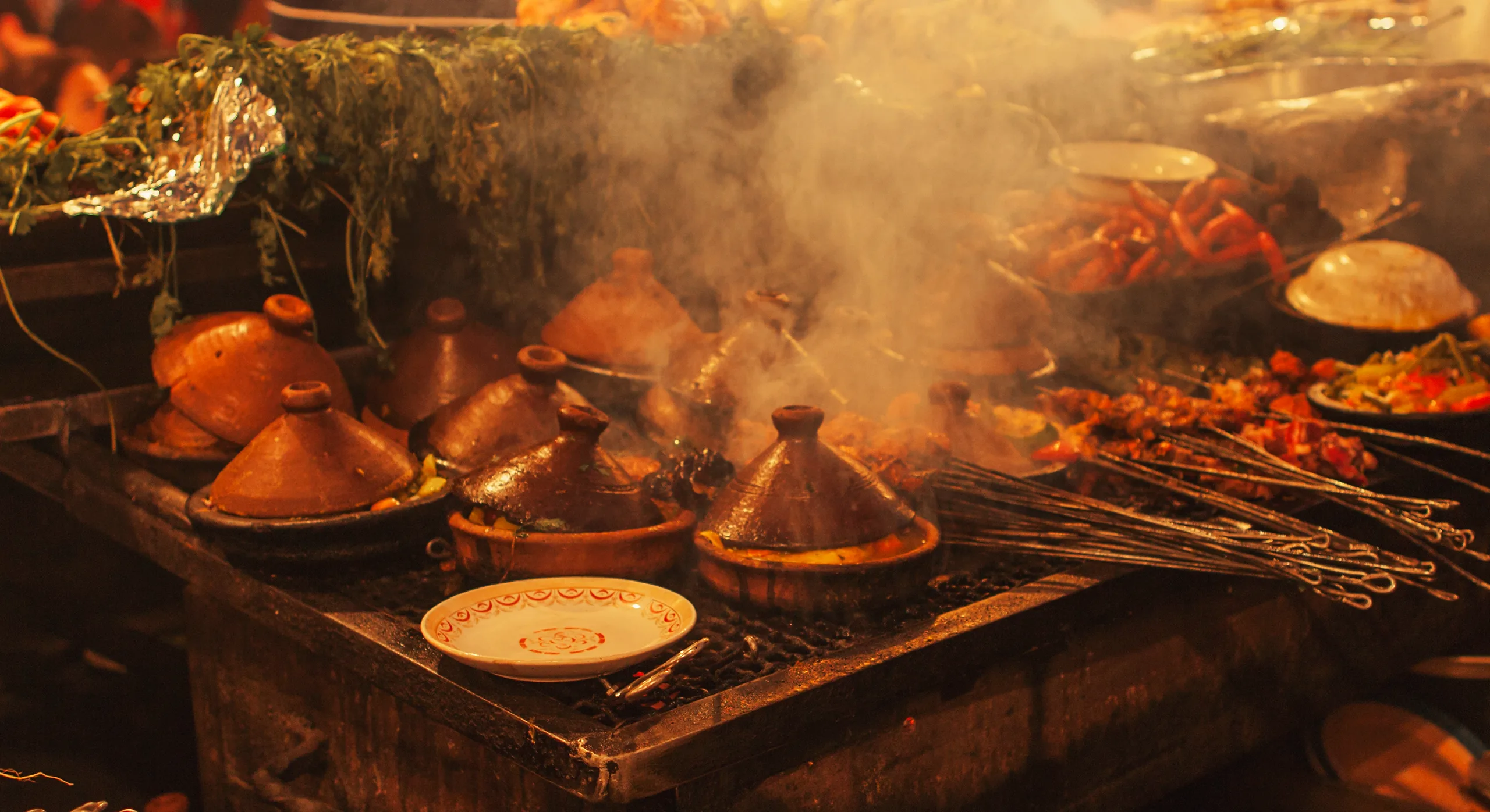 Tagines and grills smoking at a food stall on Jemaa el-Fnaa
